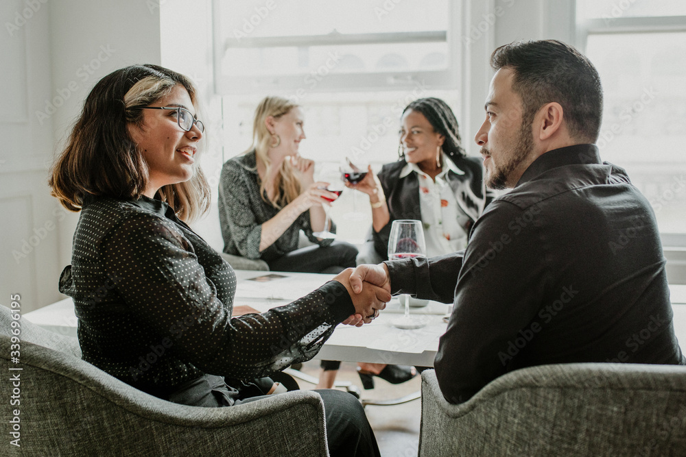 Business people drinking wine together