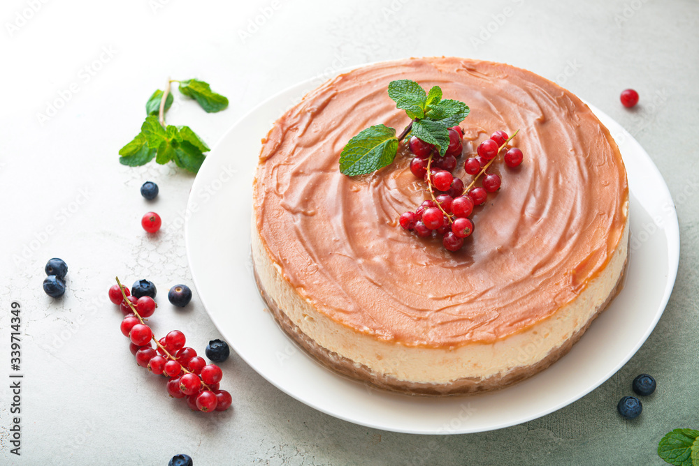 Tasty cheesecake with berries on color background