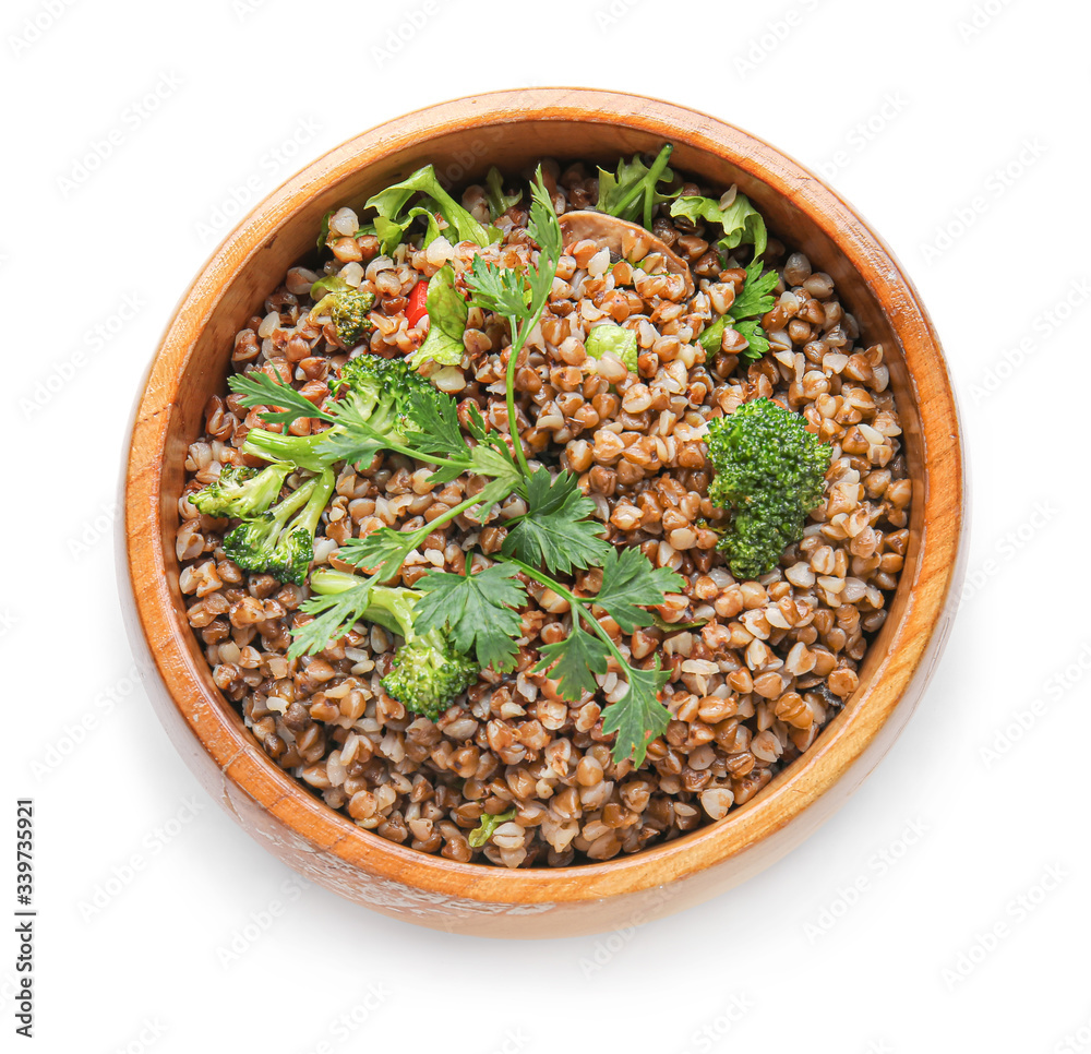 Bowl of tasty buckwheat porridge on white background