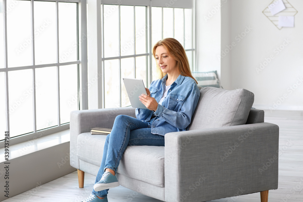 Mature woman using tablet computer for online learning at home