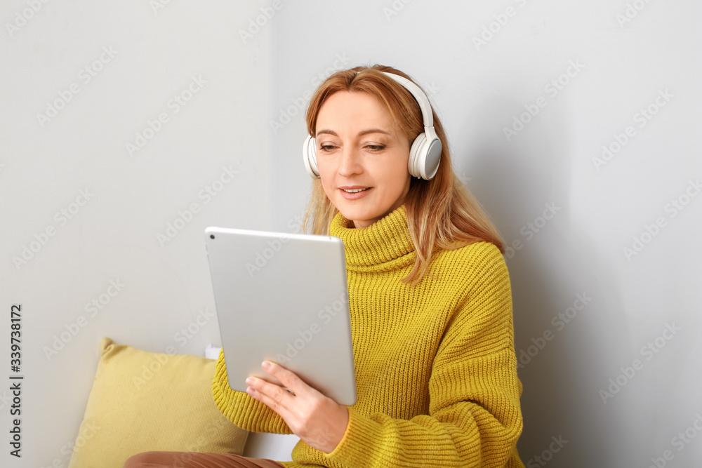 Mature woman using tablet computer for online learning at home