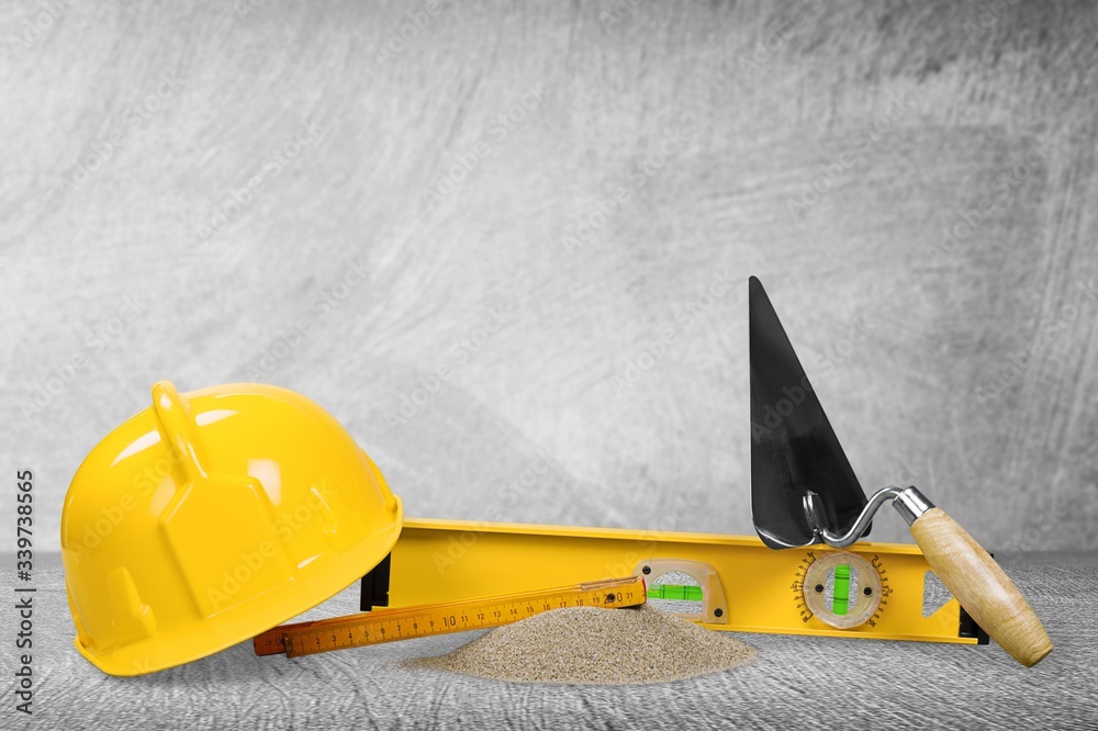 Safety helmet and construction tools on the desk