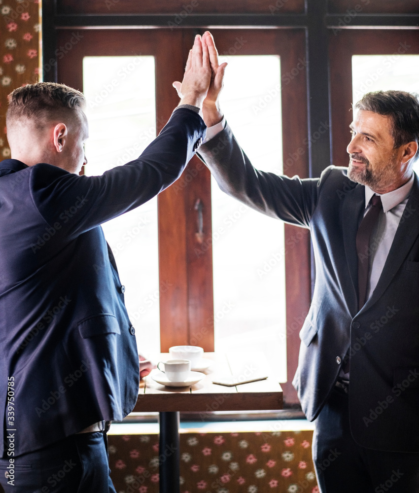 Businessmen giving a high five