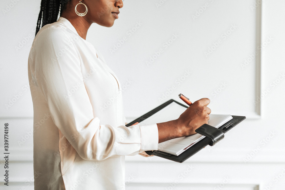 Businesswoman noting in a calendar