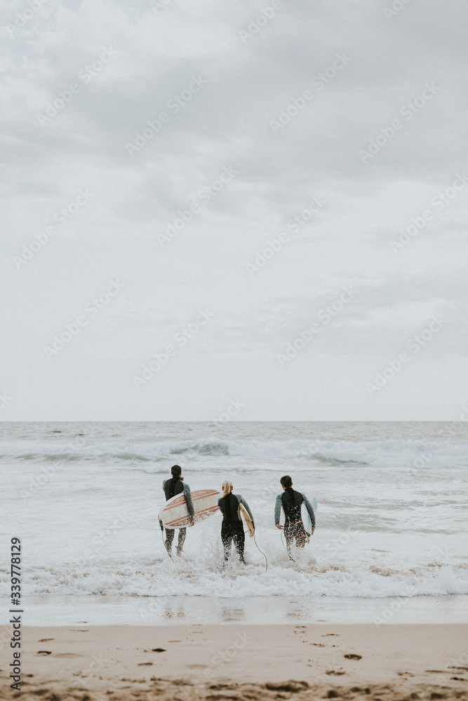 Surfers going into the water