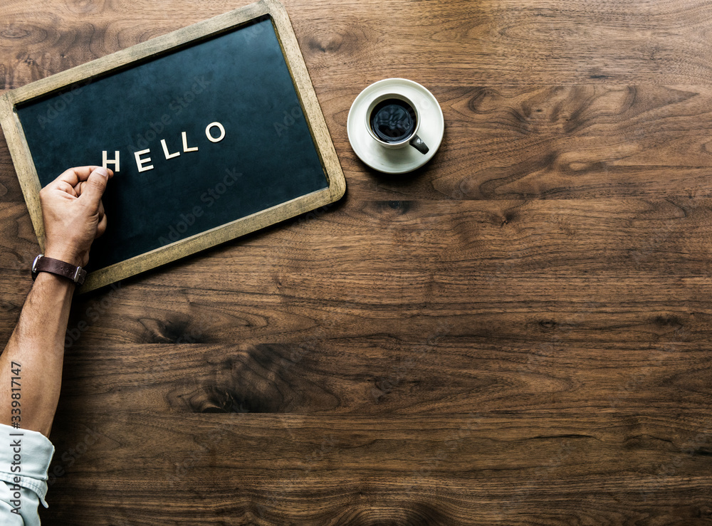 Aerial view of black board with the letter forming hello greeting concept