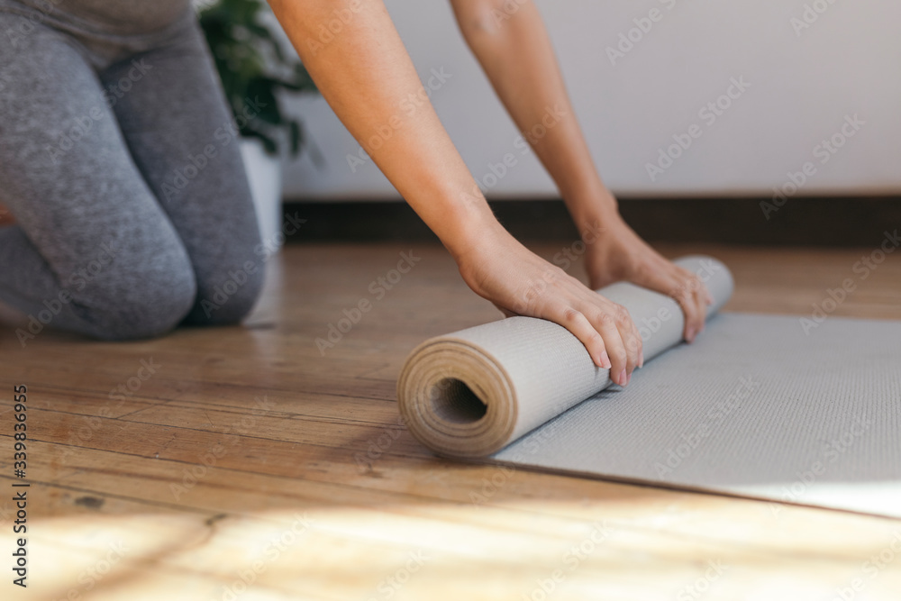 Rolling out a yoga mat