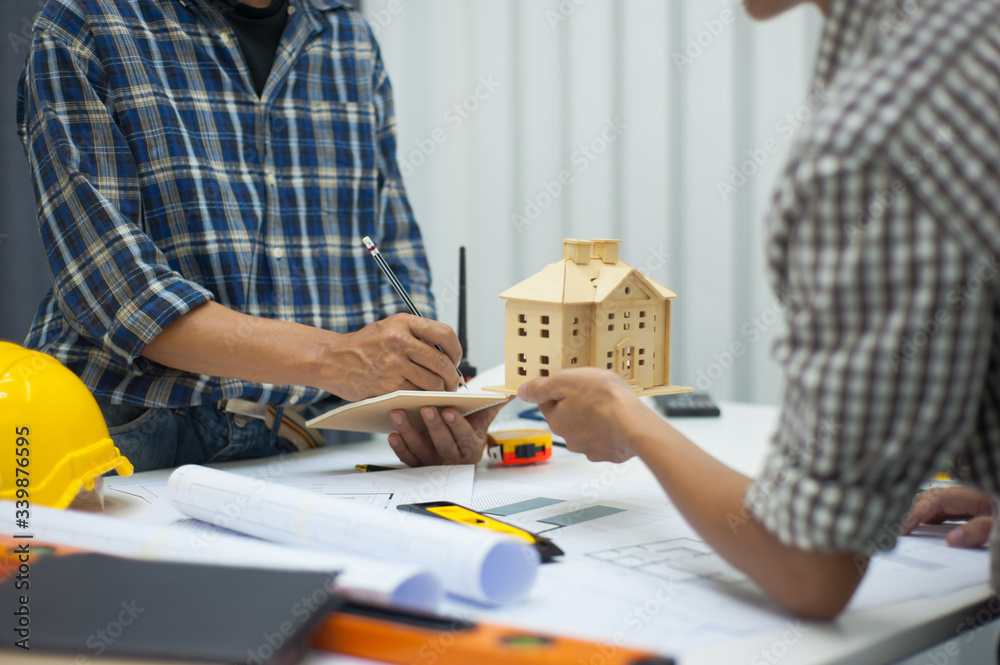 Two male architects in the office discussed housing construction projects.