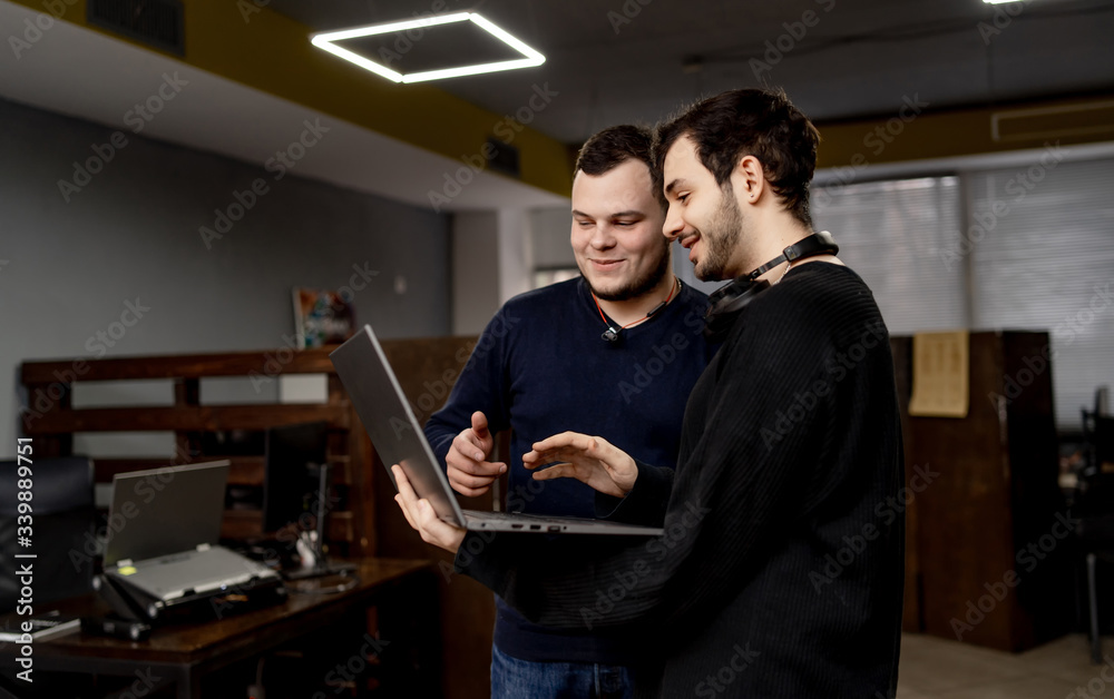 Handsome young programmers working in office. Developing programming and coding technologies.