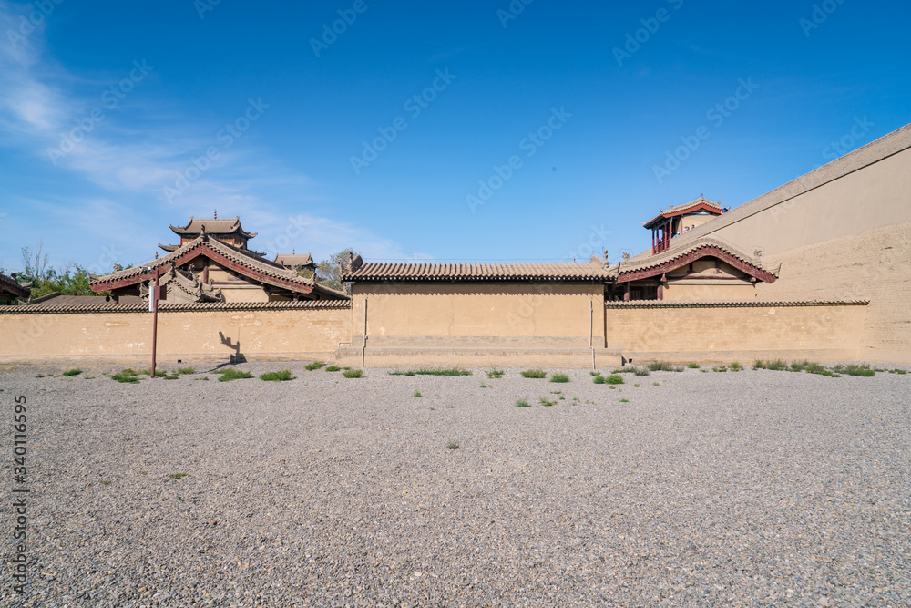 Classical house under the wall of Jiayuguan city, Gansu, China.Walls of Jiayuguan Great Wall in Gans