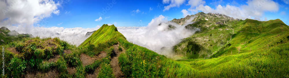 Panoramic majestic view on the Bavarian Alps and the Nebelhorn mountain with blue sky and white clou