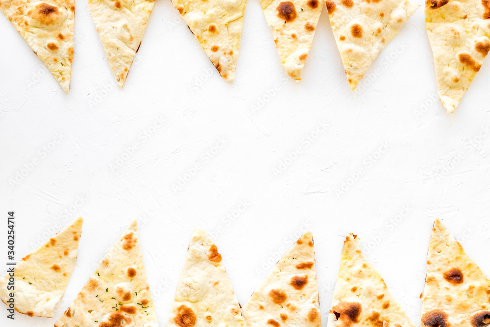 Focaccia pieces frame on white background top-down copy space