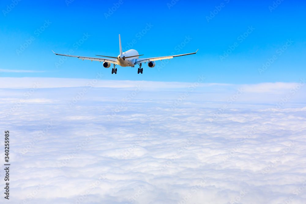 Commercial airplane flying above the clouds,travel concept.