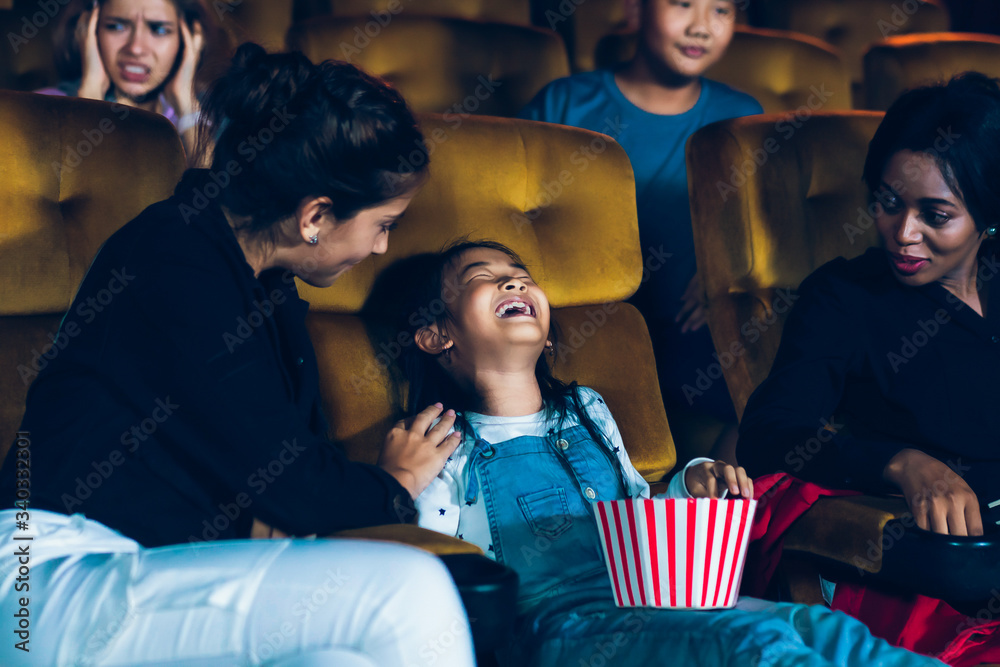 The girls cried loudly in the cinema, causing annoyance to the people sitting next to and behind the