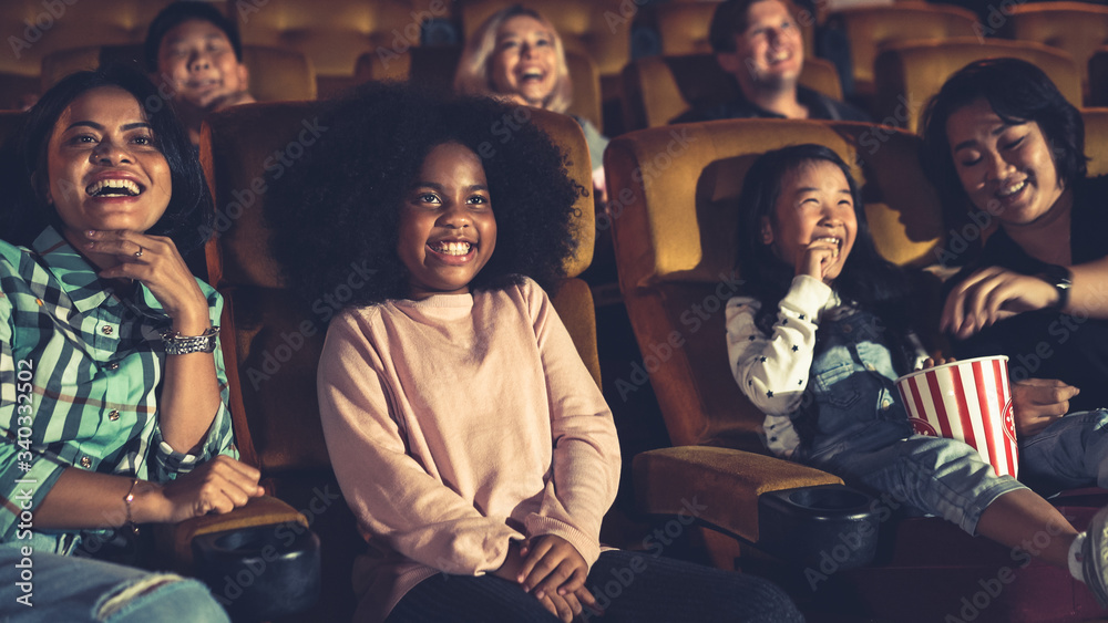 People audience watching movie in the movie theater cinema. Group recreation activity and entertainm