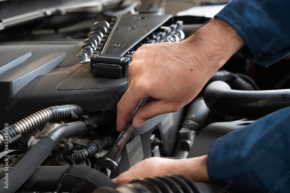 Professional mechanic providing car repair and maintenance service in auto garage. Car service busin