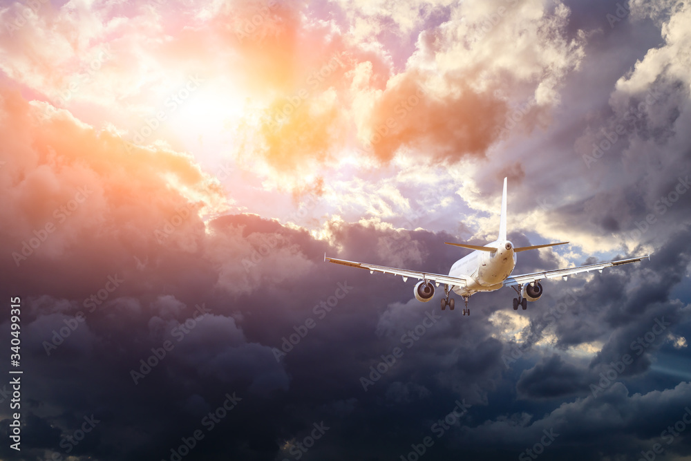 Commercial airplane flying in beautiful sky at sunset,travel concept.