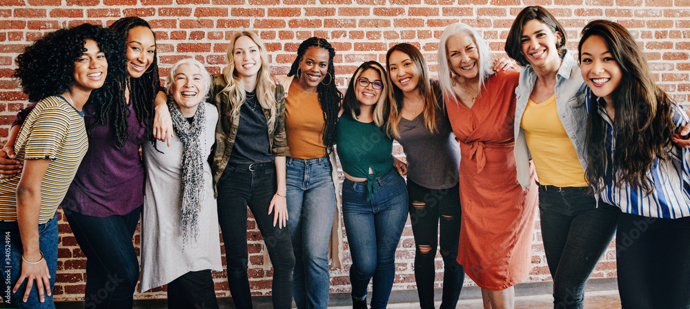 Happy diverse women in a row