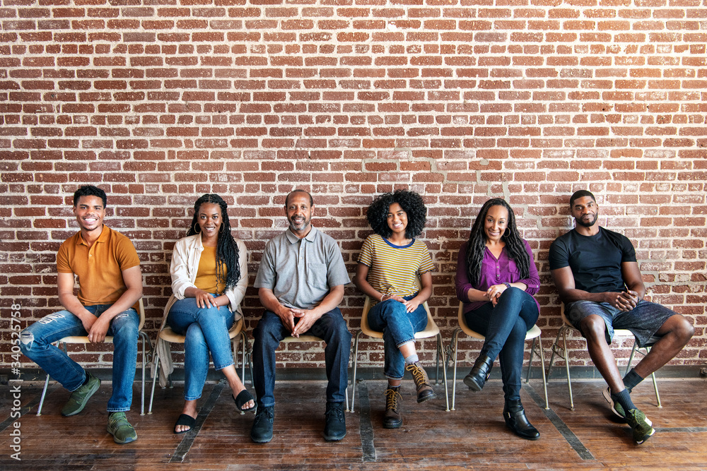 Diverse people sitting on a chair