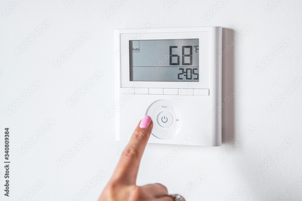 Man adjusting the thermostat