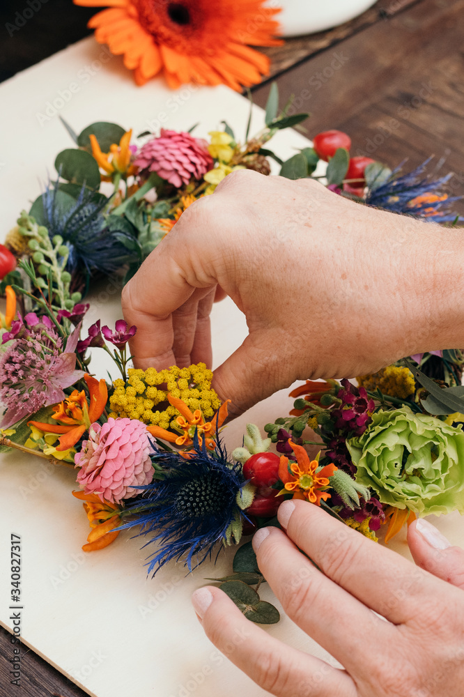 Woman arranging a floral wreath