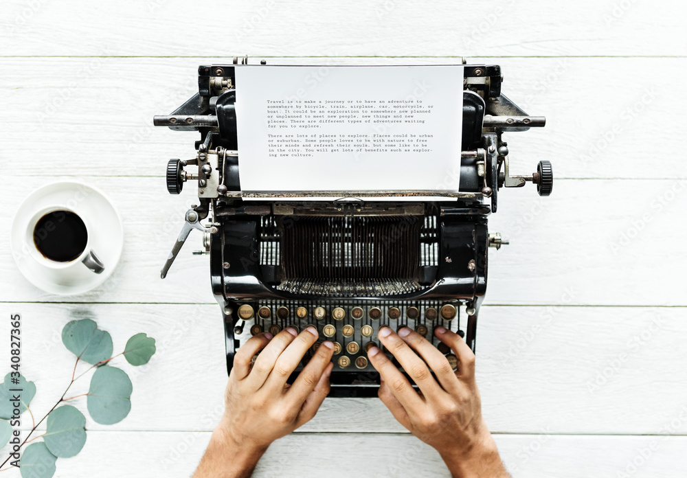 Aerial view of a man typing on a retro typewriter