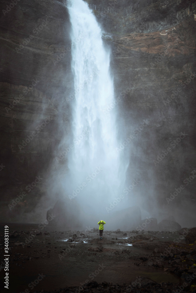 Traveler by a waterfall