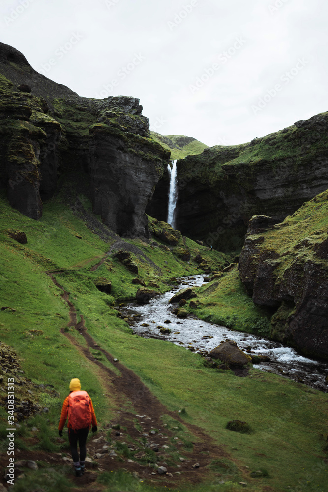 Traveler by a waterfall