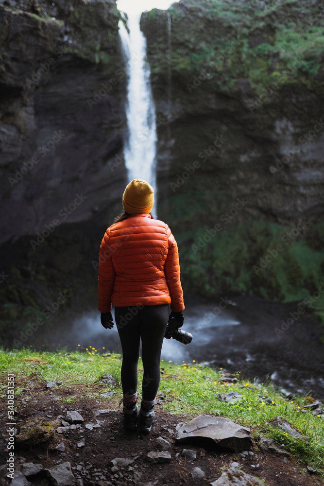 Traveler by a waterfall