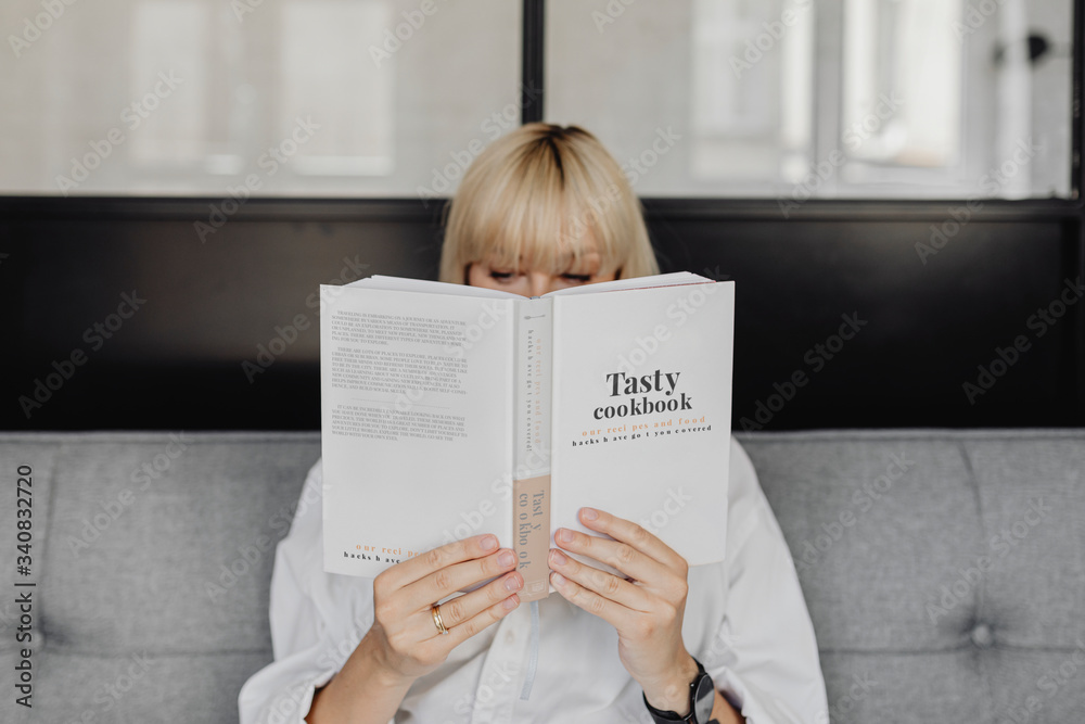 Blond woman reading a book