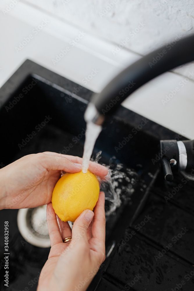 Woman washing a lemon