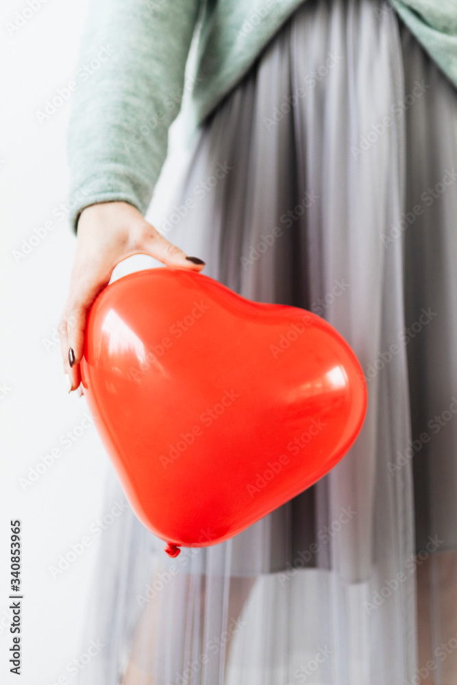 Woman holding a heart balloon