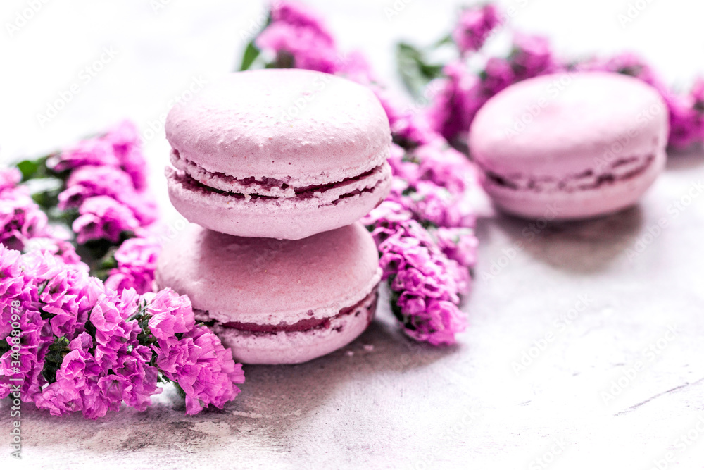 Trendy woman pattern with spring flowers and macaroons on plate