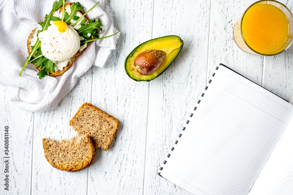 sandwich with poached eggs on wooden background top view mockup