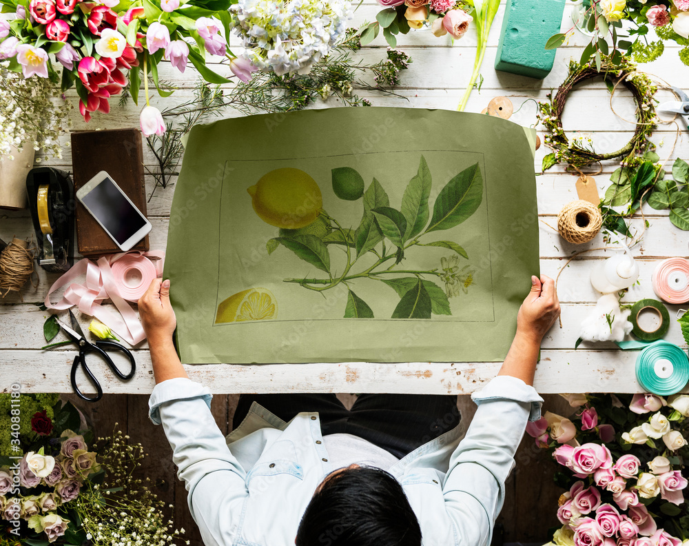 Florist Showing Empty Design Space Paper on Wooden Table with Fresh Flowers Decorate