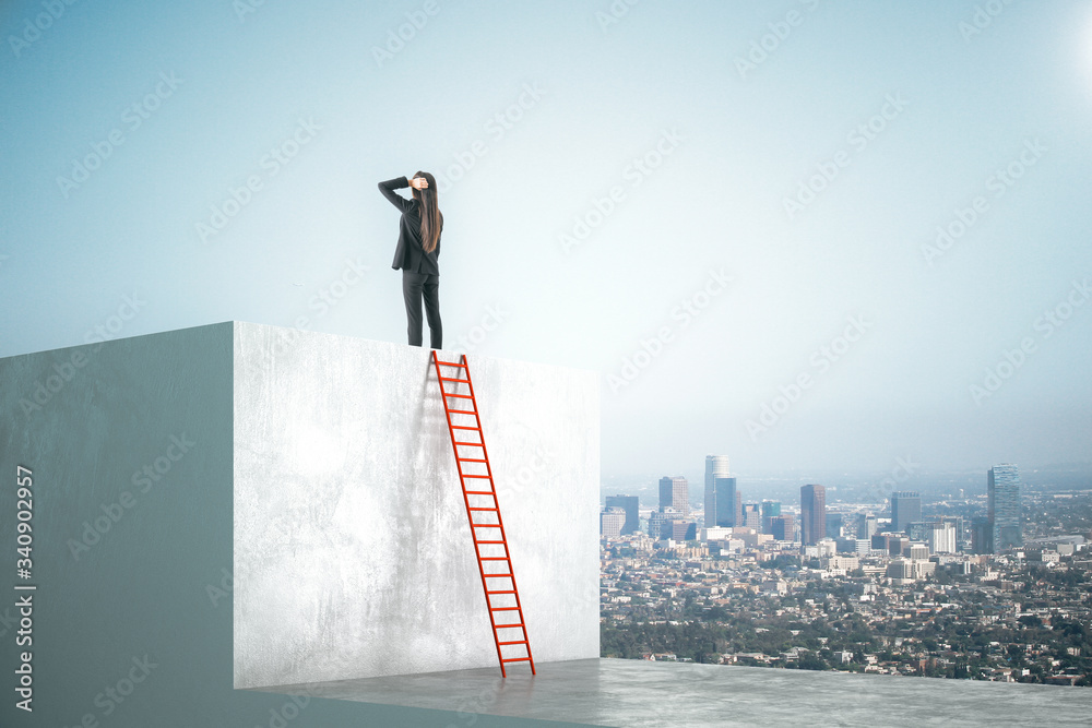 Businesswoman standing on gray cube with ladder and look into distance.