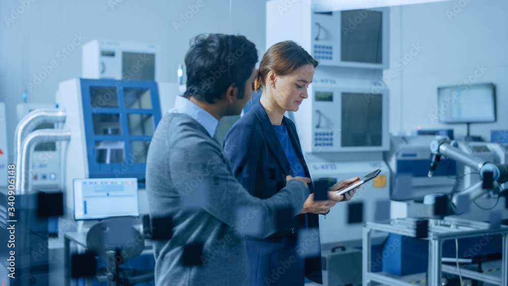 Modern Factory: Female Project Manager and Male Engineer Walk Through High Tech Development Facility