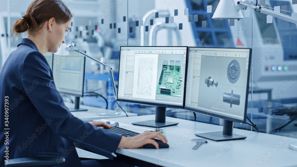 Female Engineer Working on a Personal Computer, Two Monitor Screens Show Chroma Key / Green Screen D