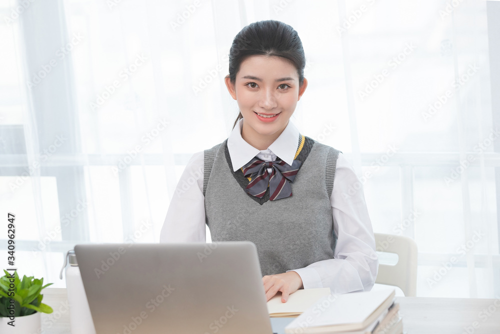 Asian female students taking classes on the Internet