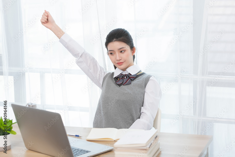 Asian female students taking classes on the Internet