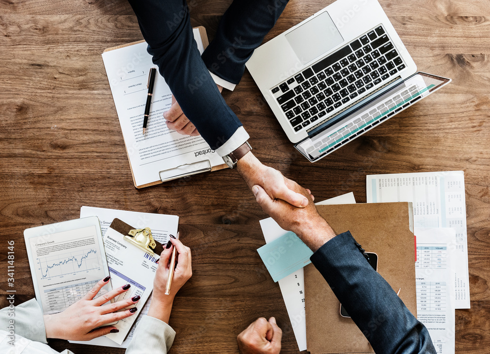 Business people shaking hands together