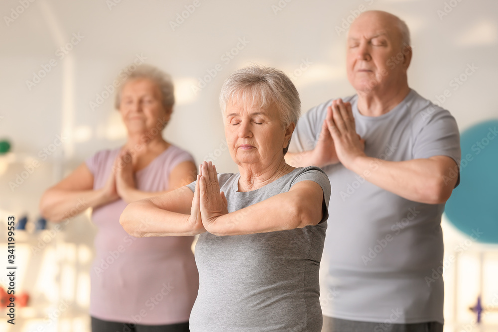 Elderly woman exercising in gym