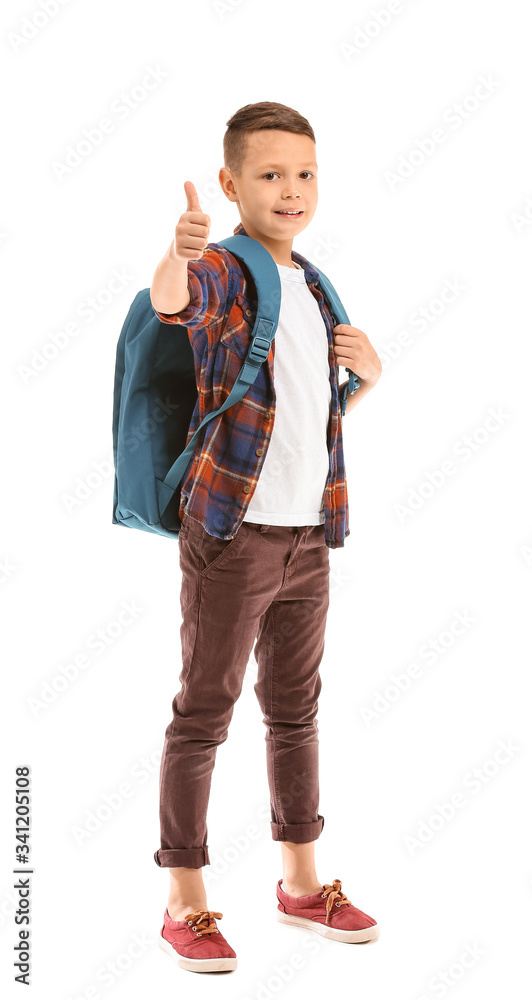 Cute little schoolboy showing thumb-up on white background