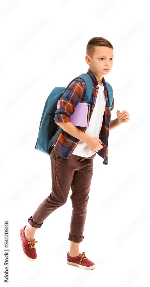 Cute running little schoolboy on white background