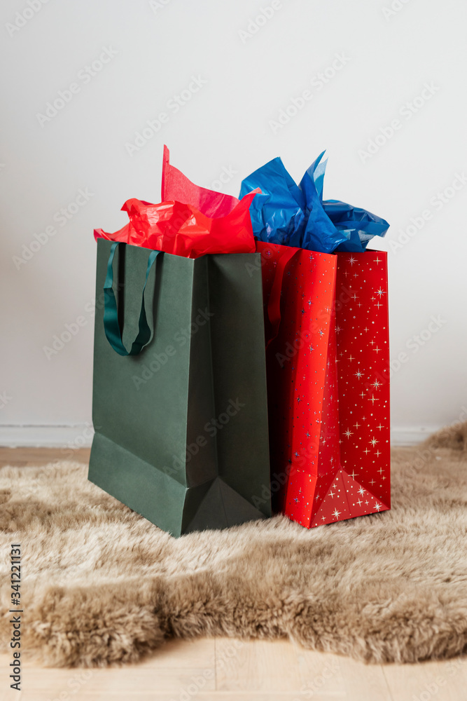 Colorful paper bags on a beige mat