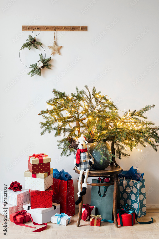 Presents by a wooden chair with Christmas tree