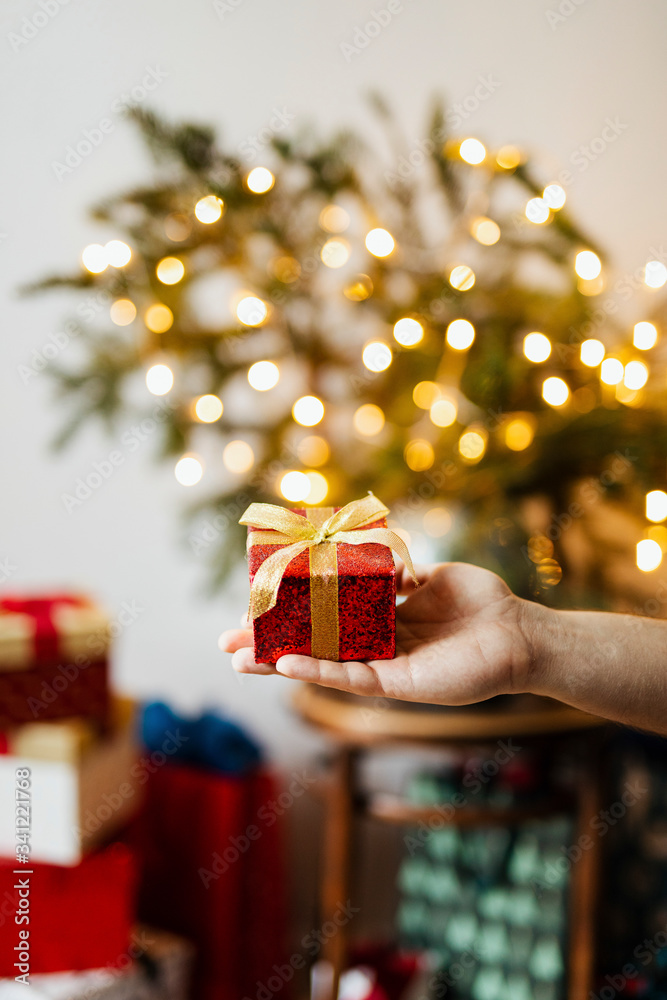 Man holding a glittery Christmas present