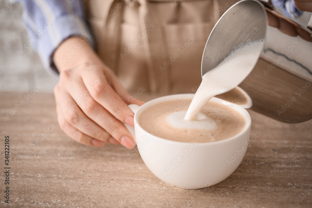 Barista preparing tasty cappuccino in cafe, closeup