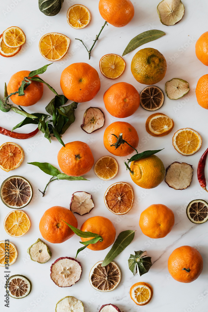 Dried oranges and clementines on a marble countertop