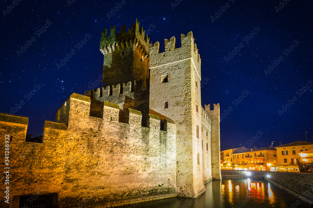 Scaligero Castle over the Garda lake in Sirmione at night, Italy